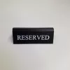 RISERVATO table sign, black faux leather, white print, small